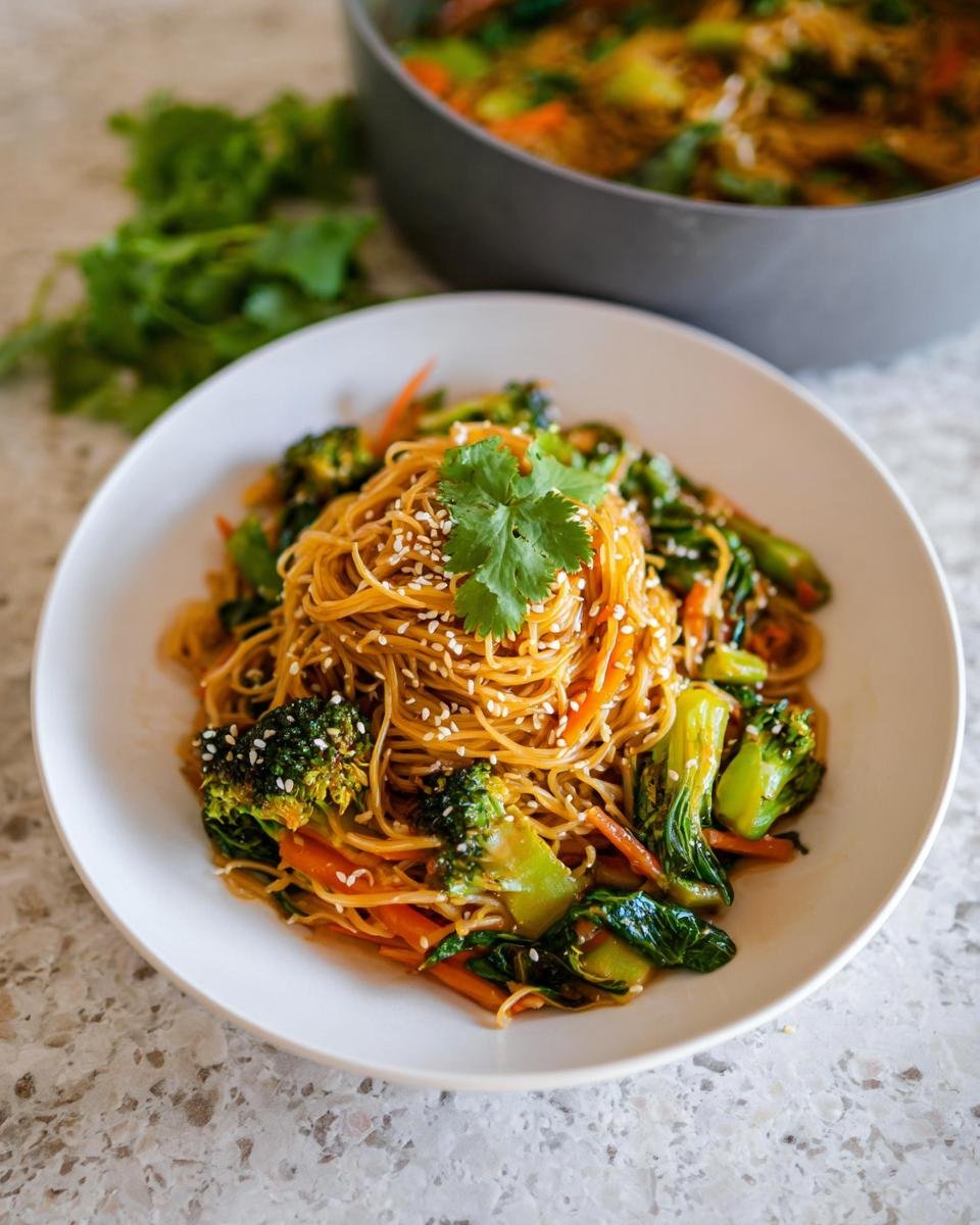 Eine Schüssel mit Schnelle Teriyaki-Nudeln mit Gemüse, garniert mit Sesam und Koriander.